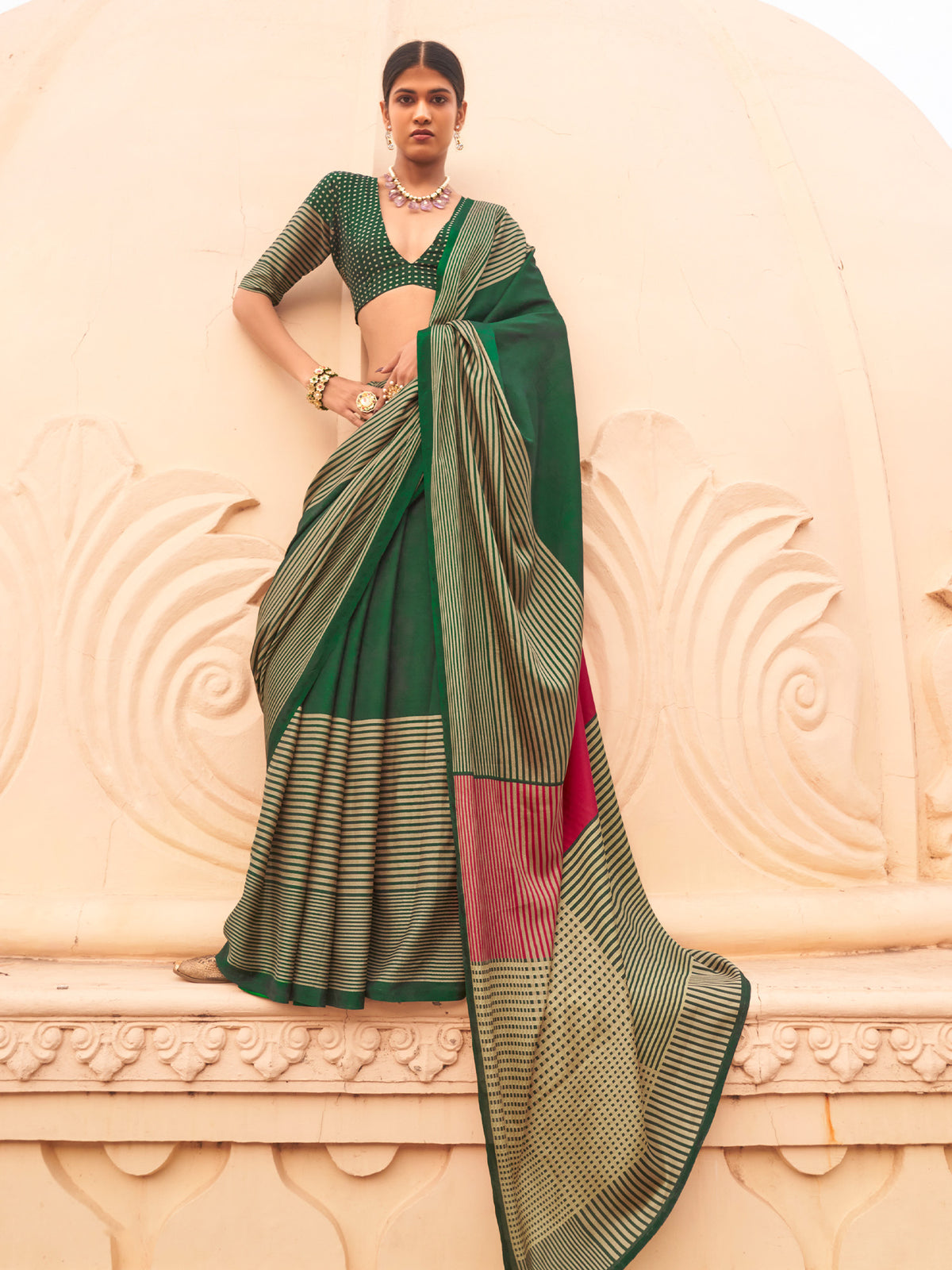 Woman wearing green silk blend saree with striped pattern design and green blouse