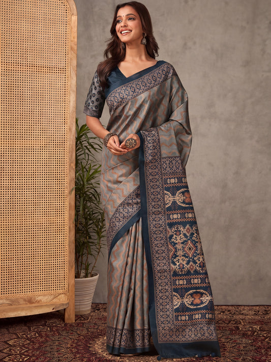 Woman wearing grey silk blend saree with striped pattern design and teal blue blouse
