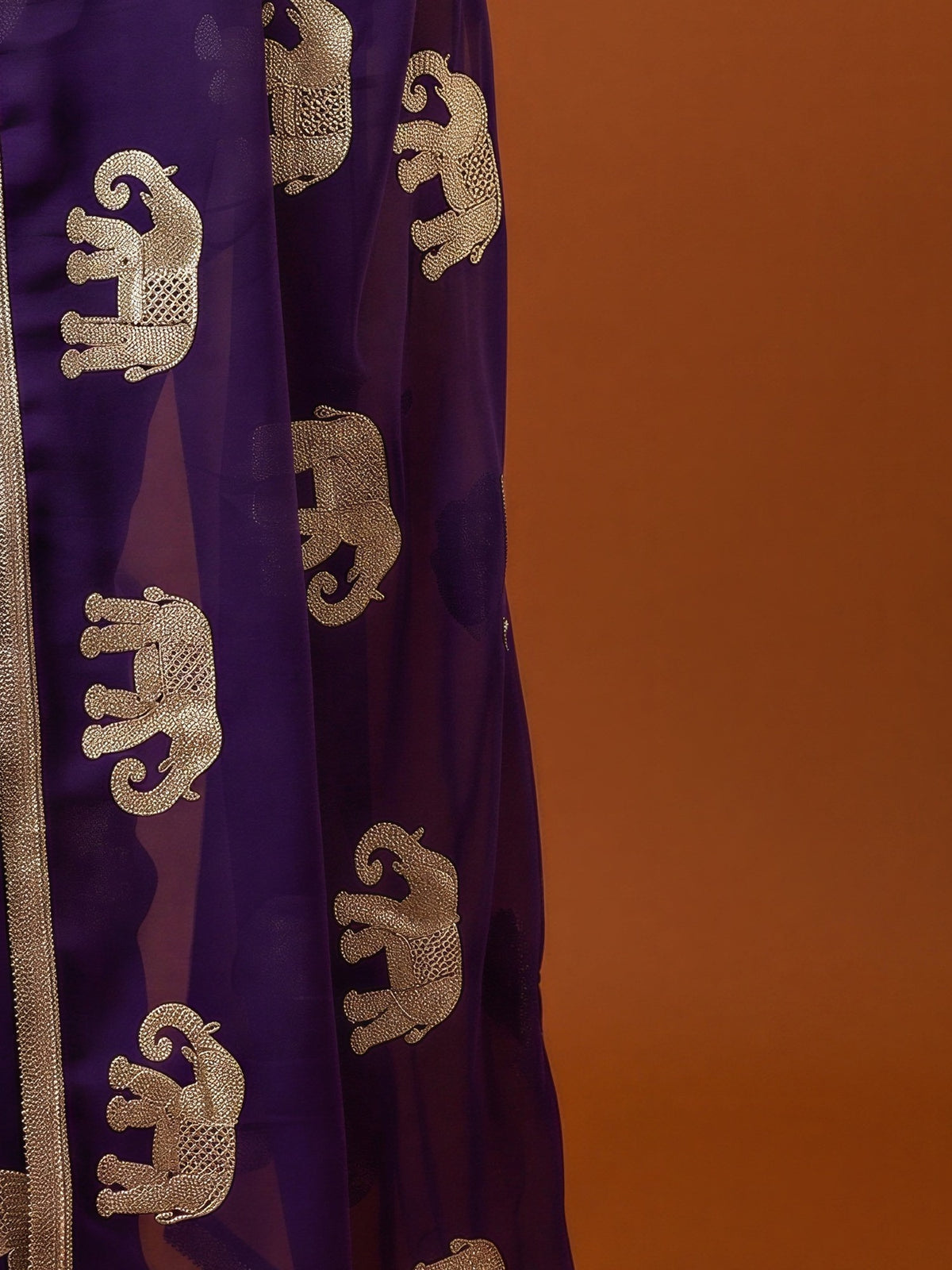 Pallu detail of purple georgette saree showing embroidered motif work and embellished border