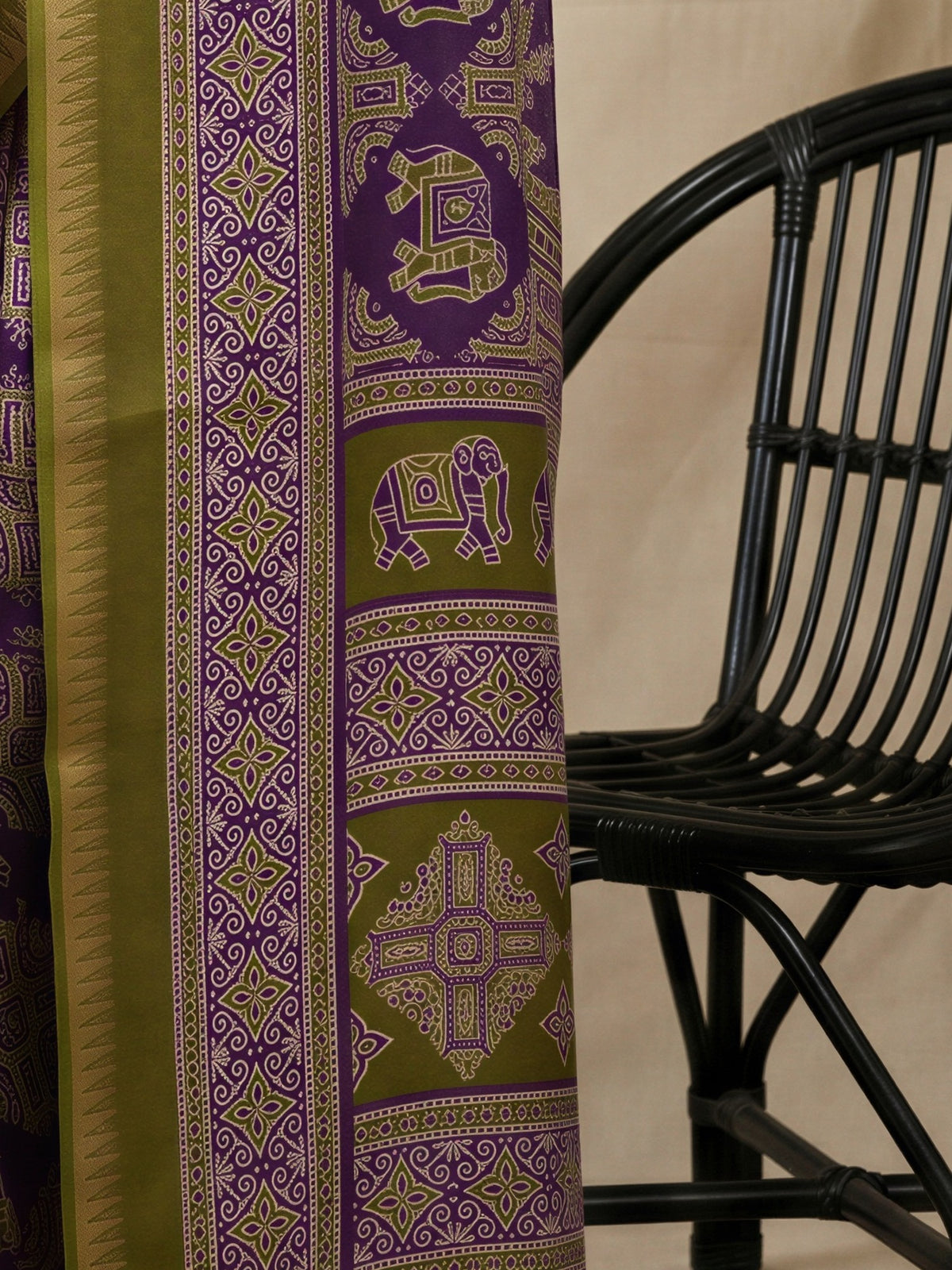 Pallu detail of purple georgette saree showing traditional indian motif work and zari border