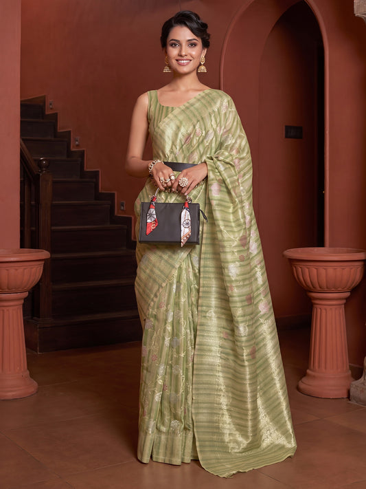 Woman wearing light green silk blend saree with all-over floral design and light green blouse