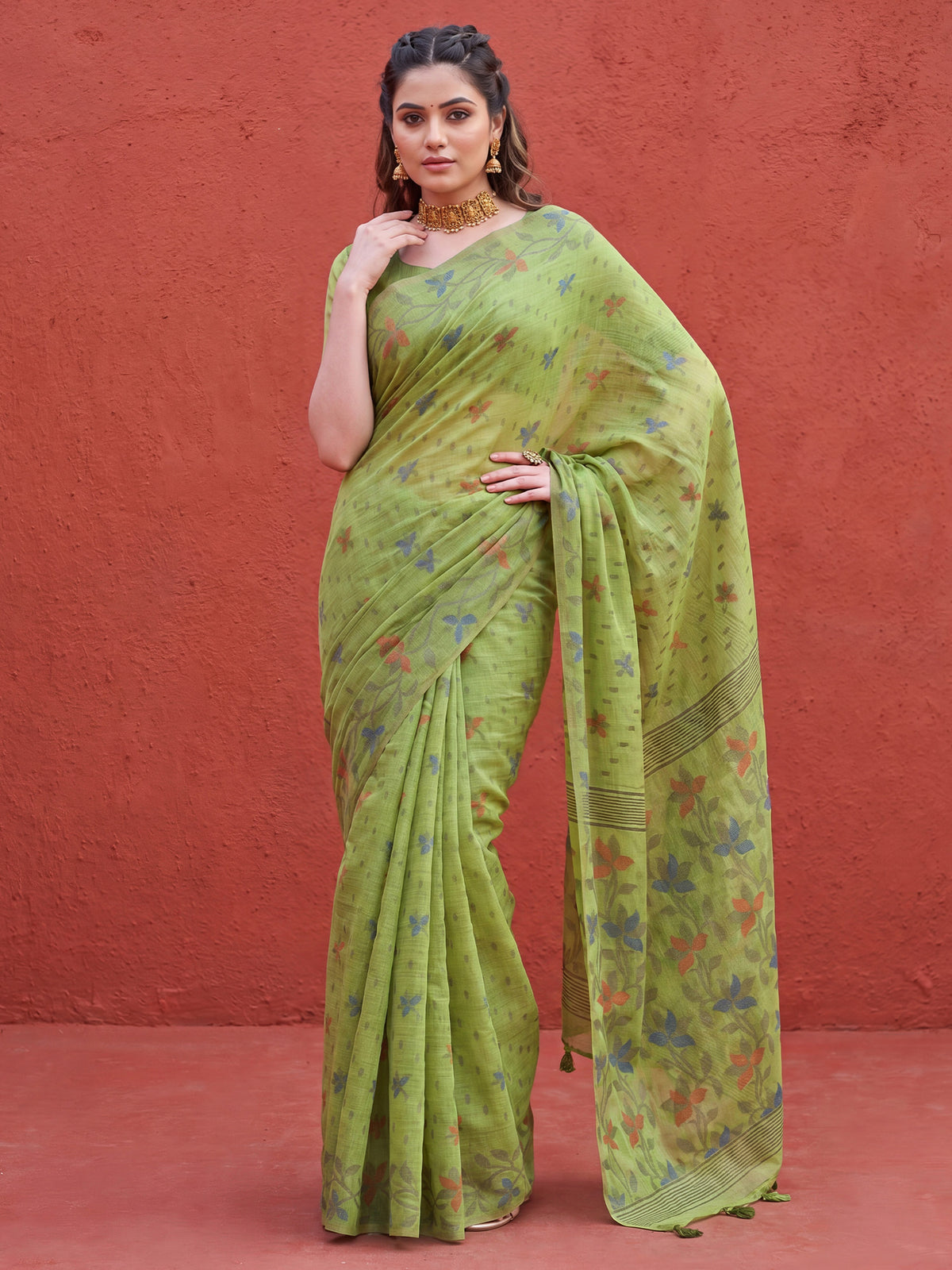 Woman wearing green linen saree with all-over floral design and green blouse