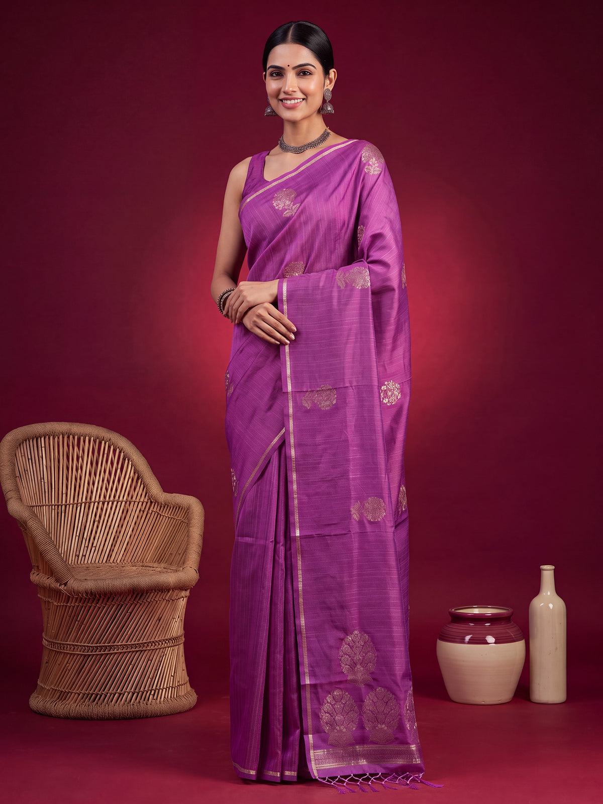 Woman wearing violet satin silk saree with zari butta (metallic motif) work and violet blouse
