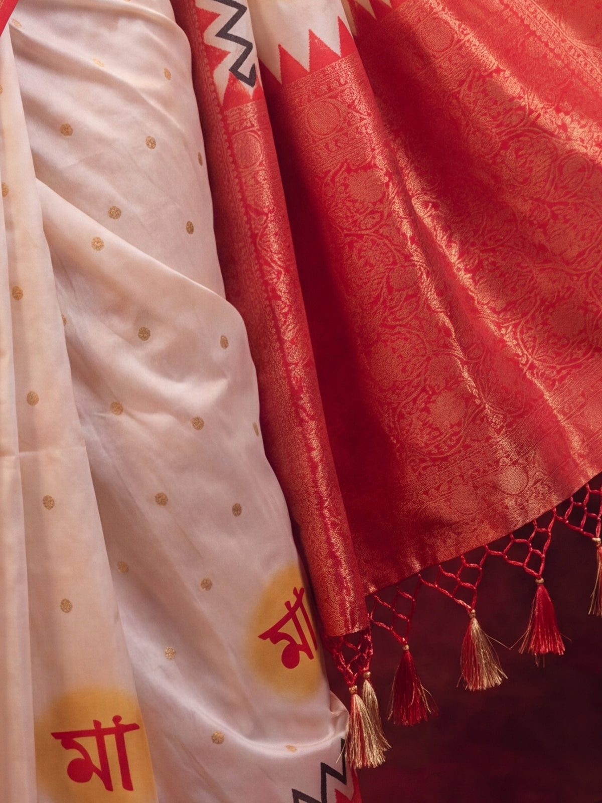 Pallu detail of off white satin silk saree showing all-over floral design and zari border