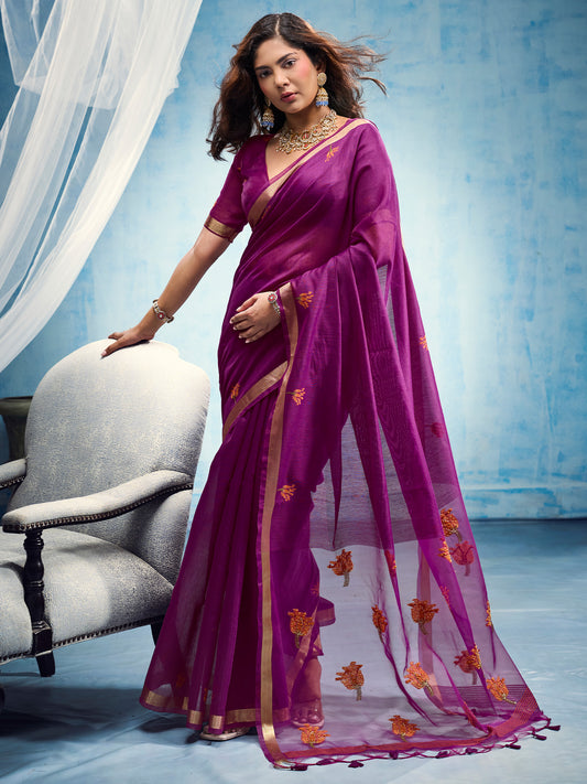 Woman wearing magenta muga cotton saree with embroidered motif work and magenta blouse