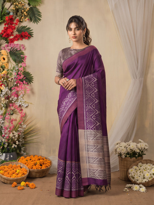 Woman wearing magenta silk cotton saree with ikat resist-dyed pattern and mauve blouse