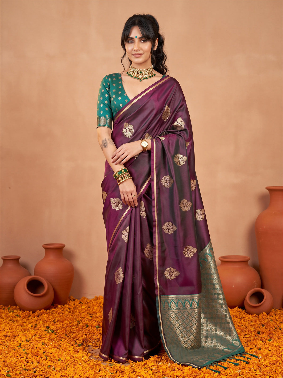 Woman wearing burgundy satin silk saree with bagh block-print motif work and teal blue blouse
