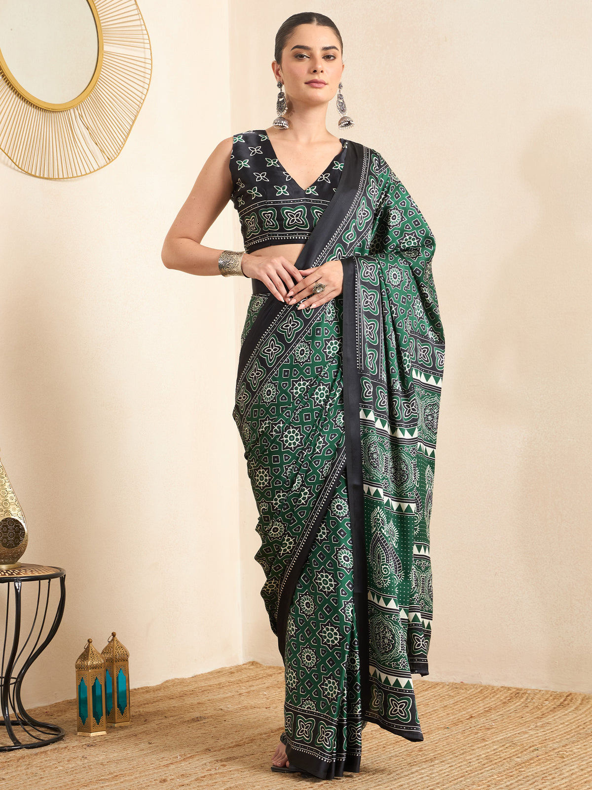 Woman wearing green crepe saree with ajrak block-print motif work and black blouse