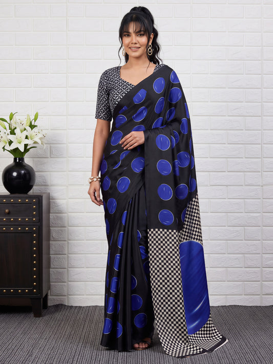 Woman wearing blue satin saree with traditional indian motif work and black blouse