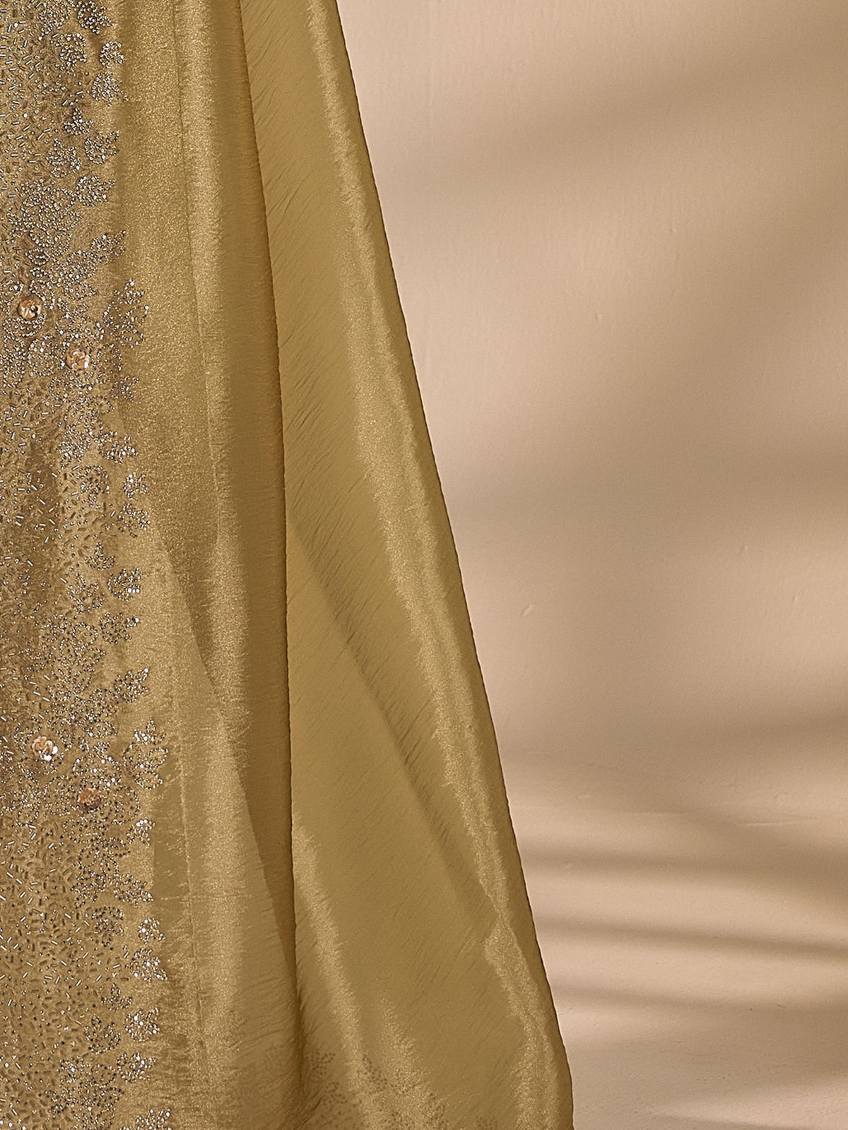 Pallu detail of olive organza saree showing applique design and embellished border