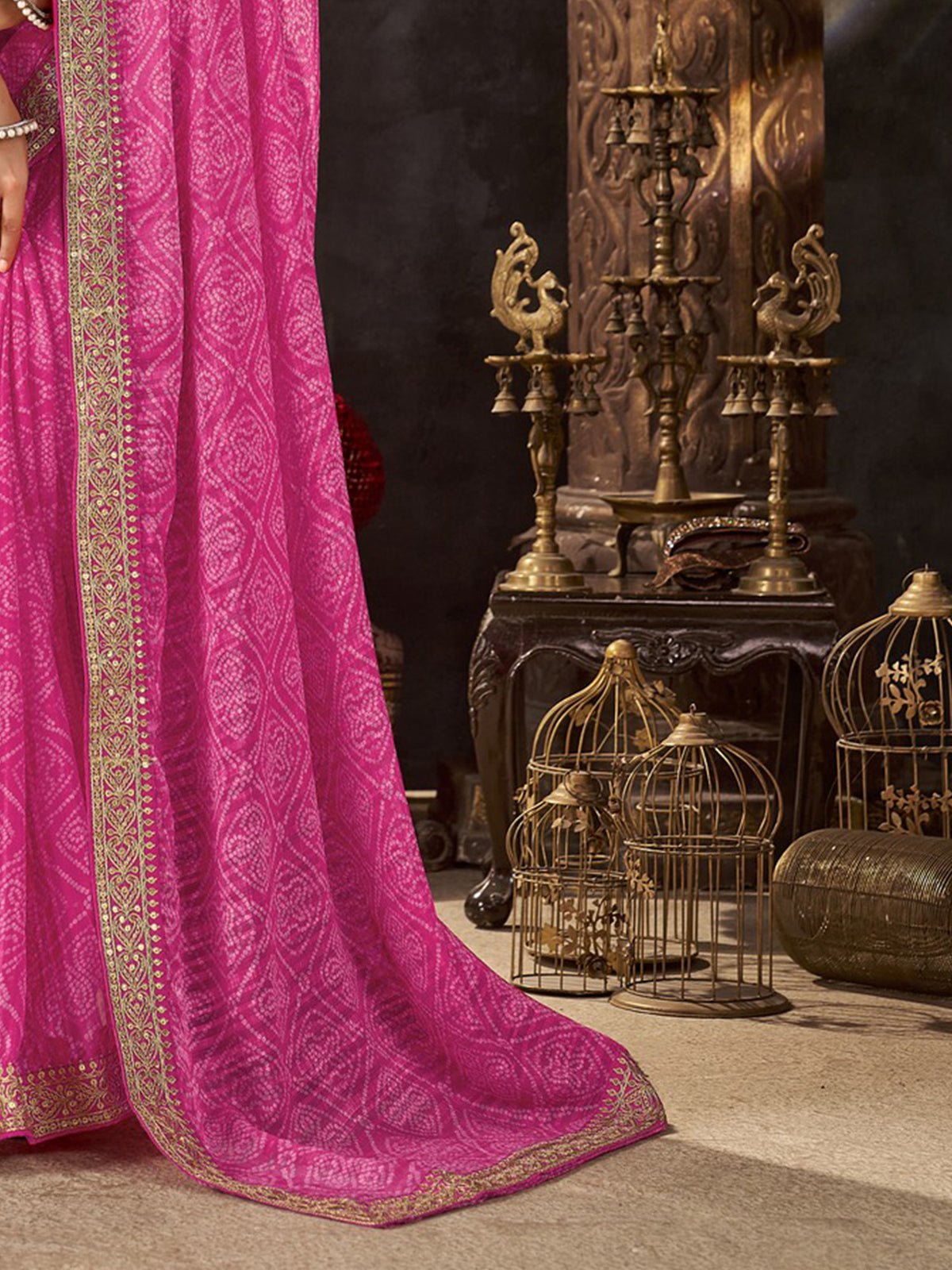 Pallu detail of pink chiffon saree showing bandhani tie-dye dot work and embellished border