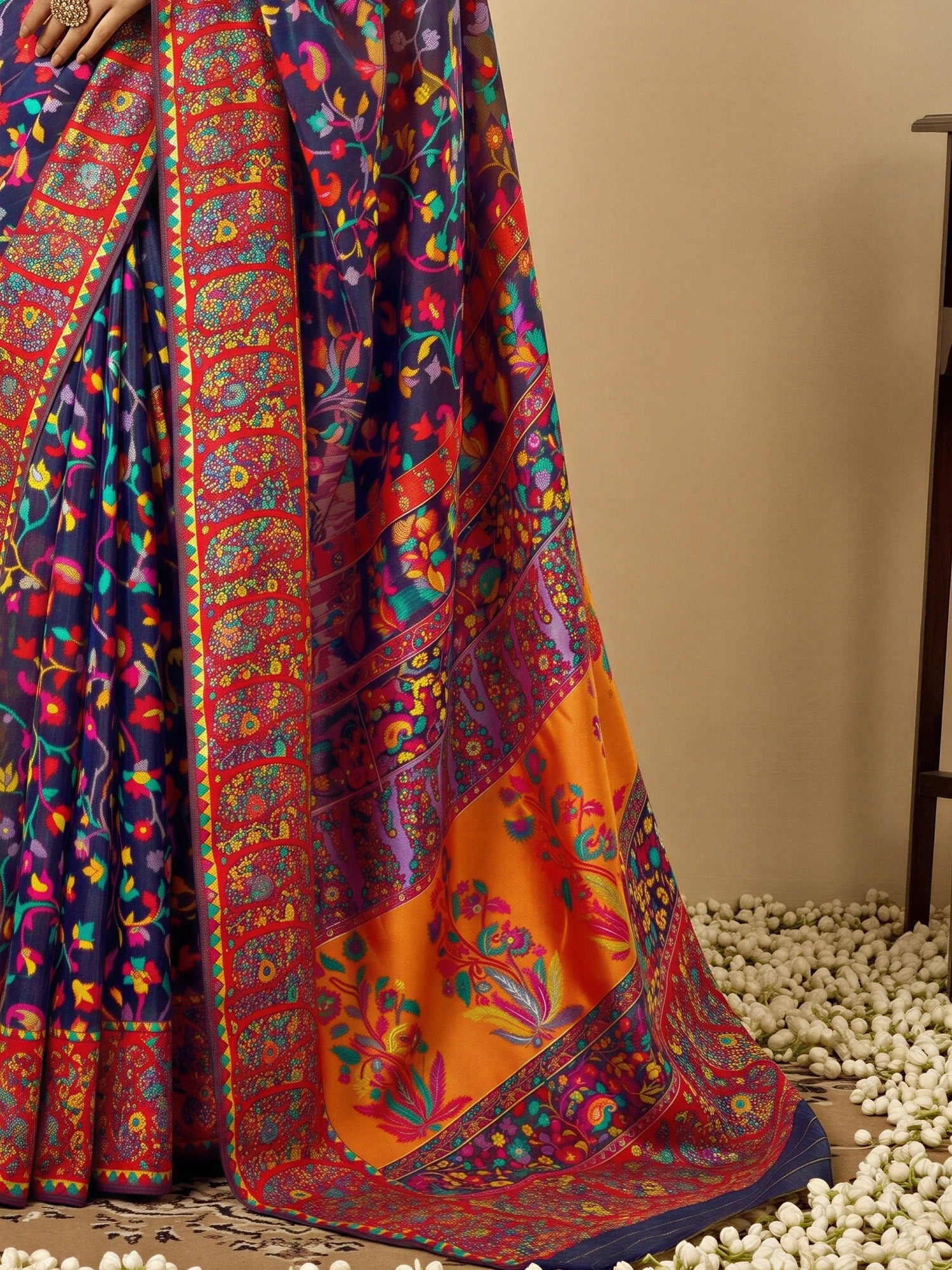 Pallu detail of navy blue cotton silk saree showing all-over floral design and woven design border