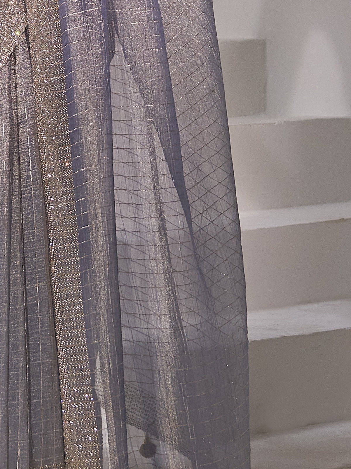 Pallu detail of light blue organza saree showing striped pattern design and embellished border