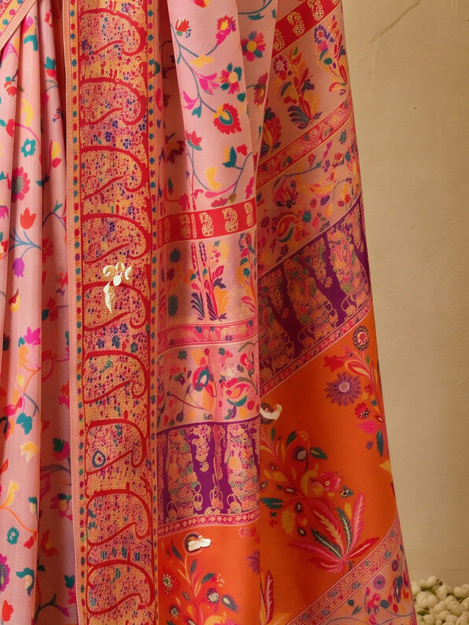 Pallu detail of pink cotton silk saree showing all-over floral design and woven design border