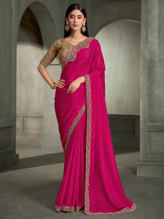 Woman wearing pink crepe saree with embroidered motif work and beige blouse
