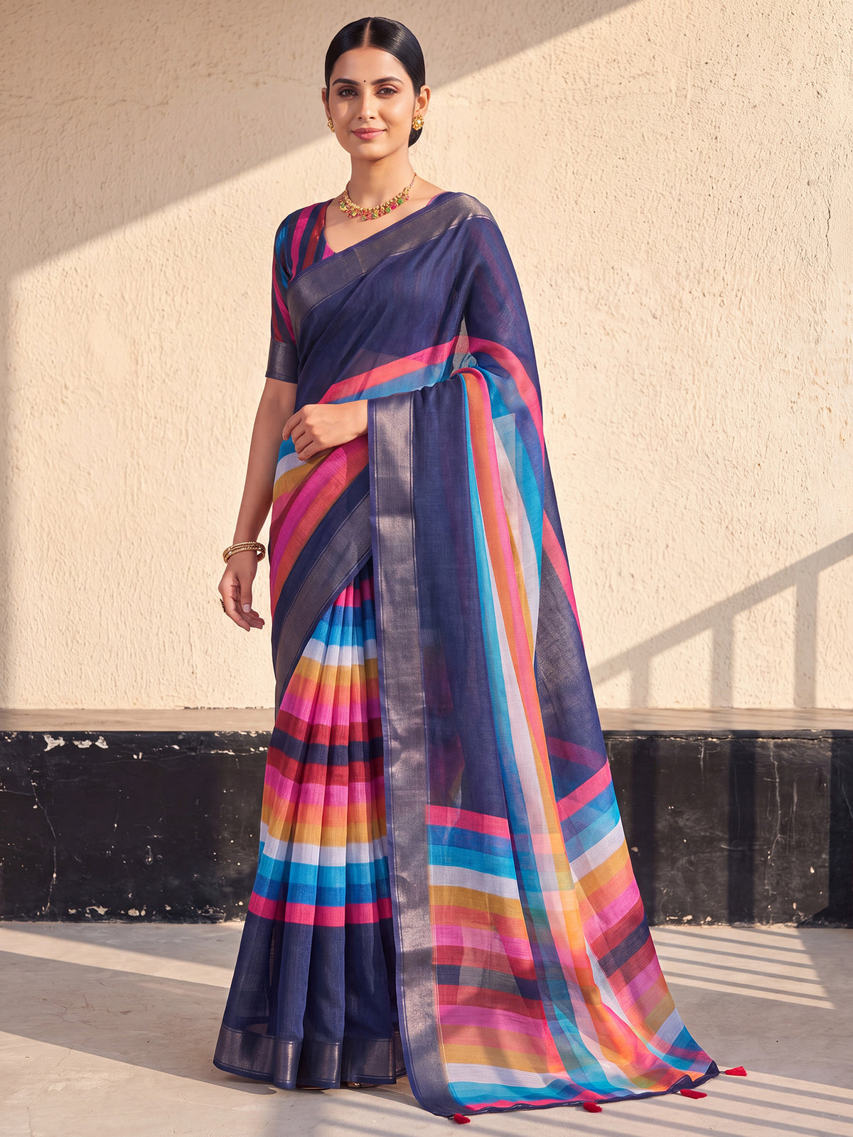 Woman wearing navy blue linen saree with colorblocked design and multicolored blouse