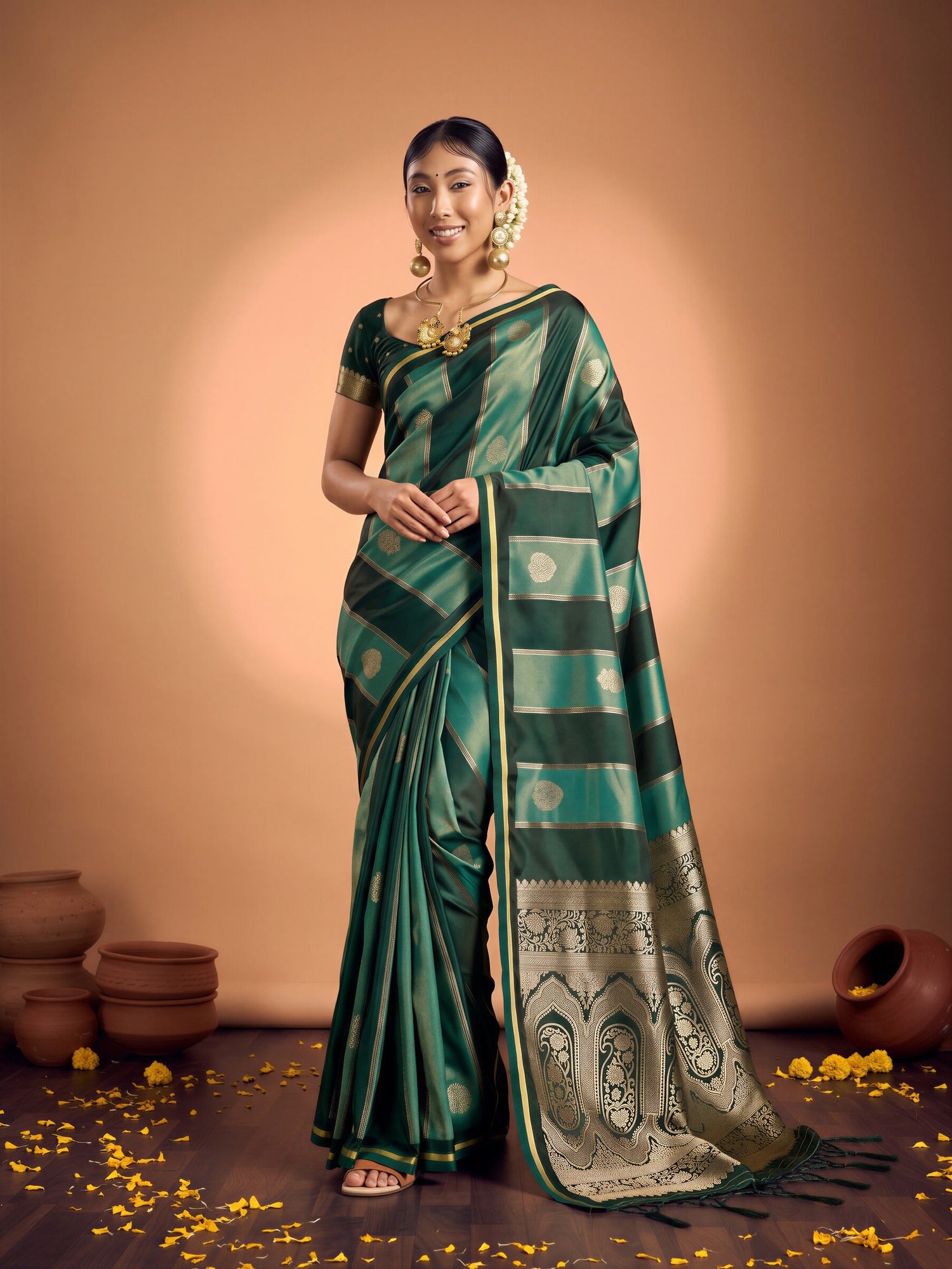 Woman wearing green satin saree with traditional indian motif work and green blouse