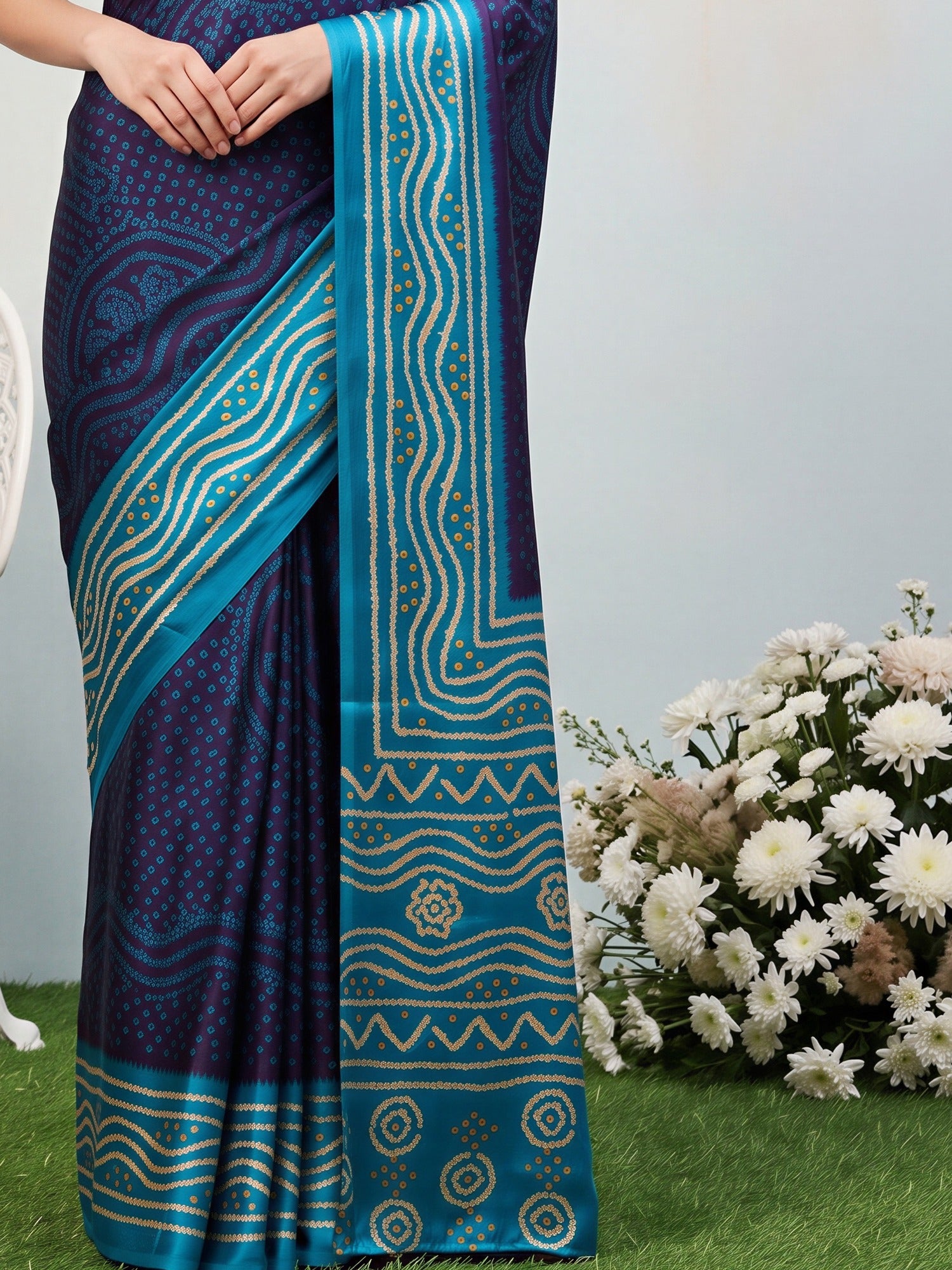 Pallu detail of navy blue satin silk saree showing bandhani tie-dye dot work and printed border