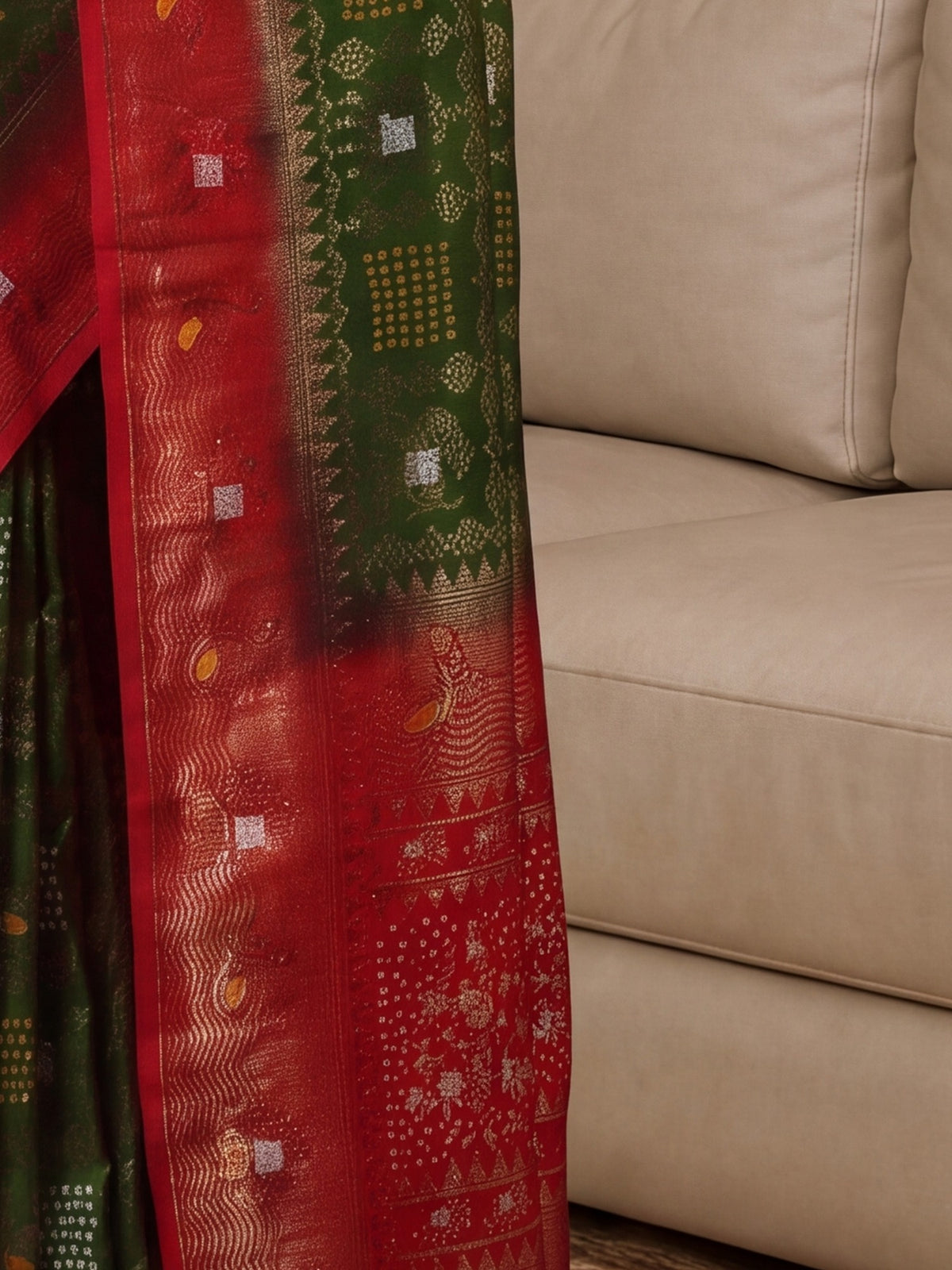 Pallu detail of light green dola silk saree showing bandhani tie-dye dot work and zari border