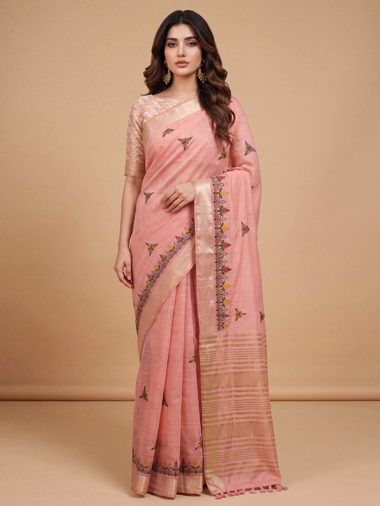 Woman wearing pink cotton linen saree with embroidered motif work and pink blouse