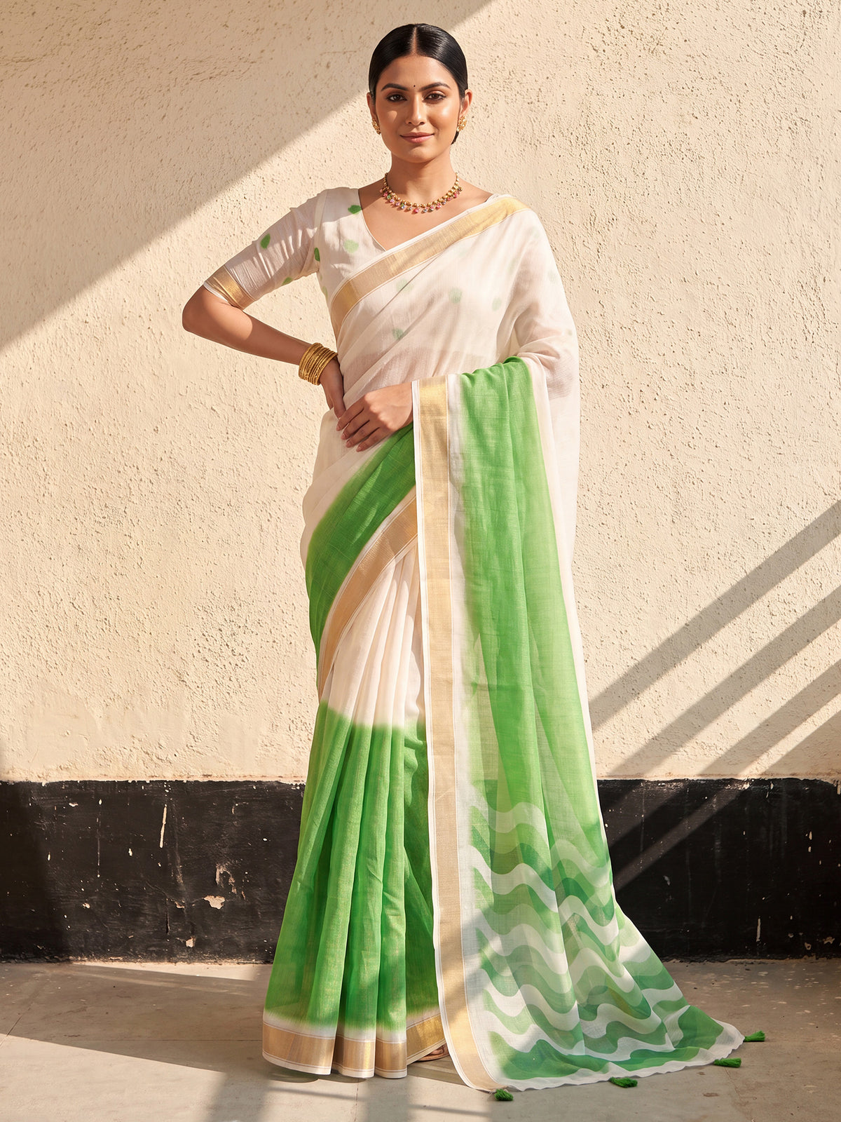 Woman wearing light green linen saree with ombre graded colour work and white blouse