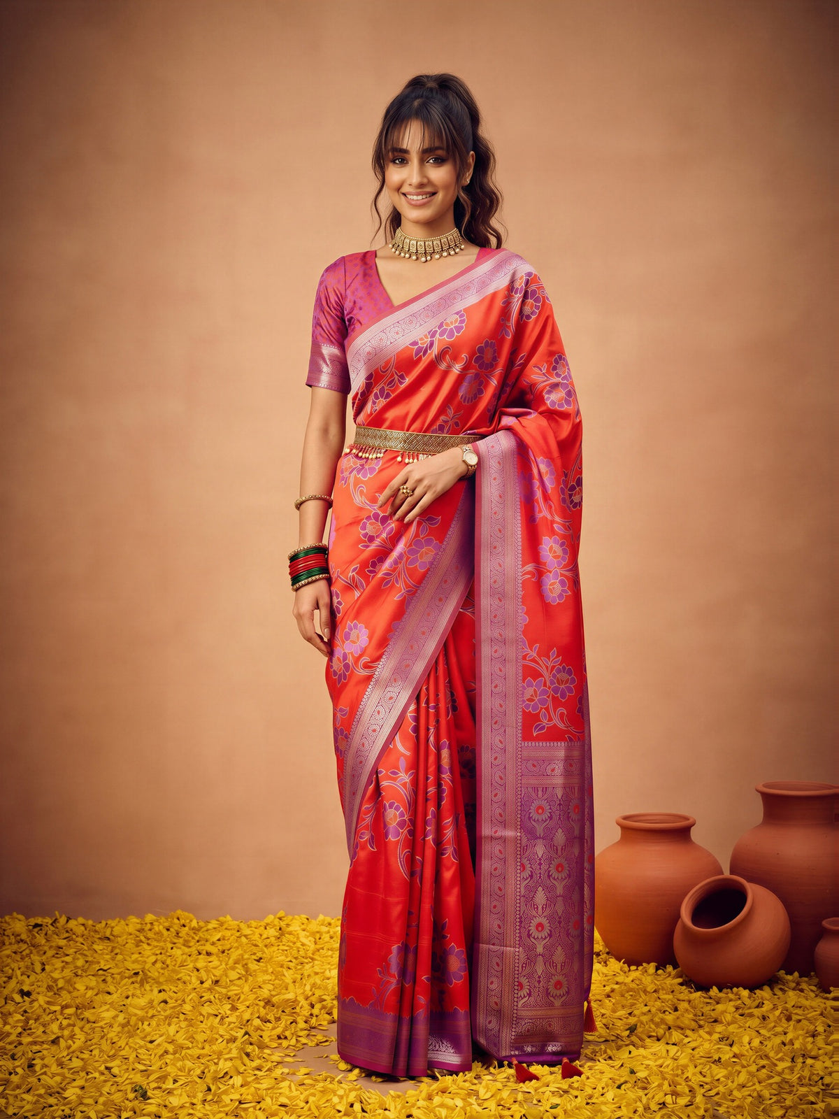 Woman wearing red satin silk saree with botanical floral and leaf design and mauve blouse