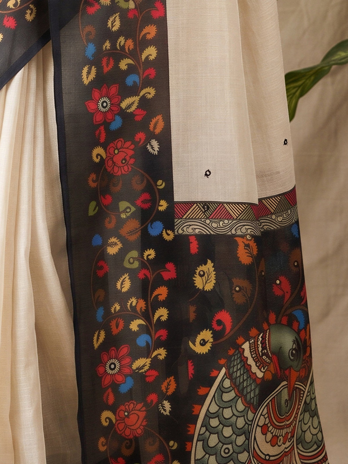 Pallu detail of off white linen blend saree showing kalamkari narrative motif work and printed border