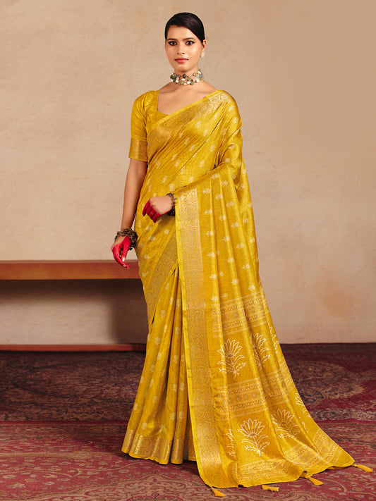Woman wearing yellow tussar silk saree with traditional indian motif work and yellow blouse