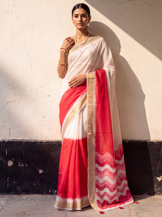 Woman wearing red linen saree with ombre graded colour work and white blouse