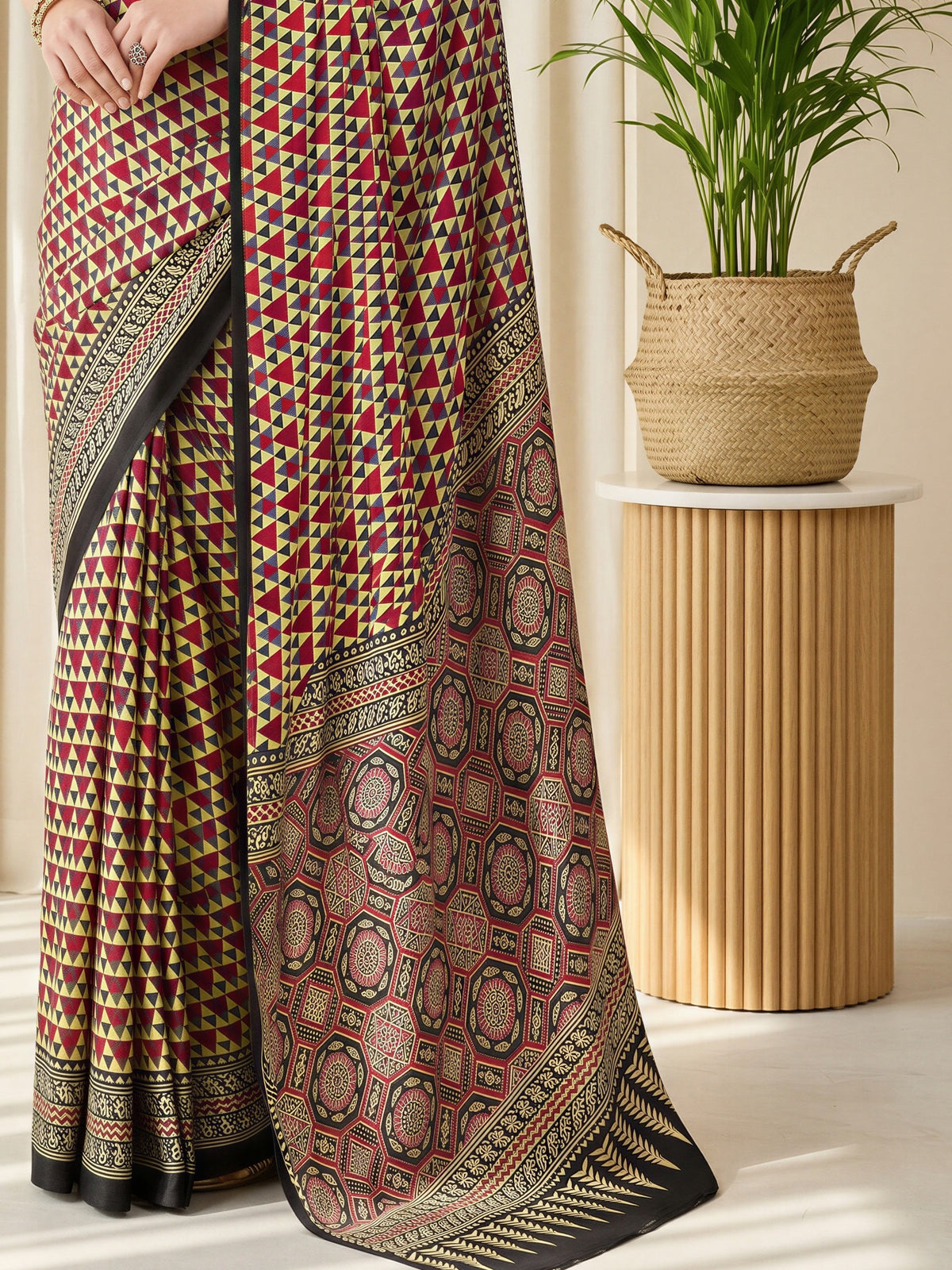 Pallu detail of red satin saree showing ajrak block-print motif work and printed border
