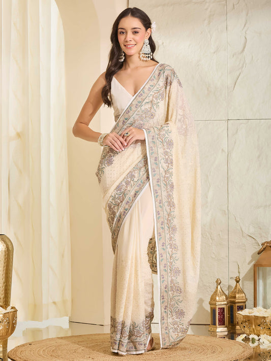 Woman wearing off white georgette saree with ornamented surface design and off white blouse