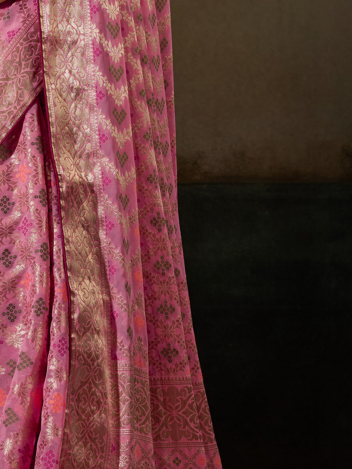 Pallu detail of pink georgette saree showing woven motif design and zari border