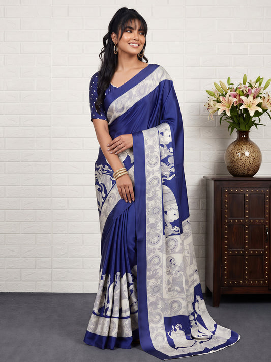 Woman wearing blue satin saree with kalamkari narrative motif work and blue blouse