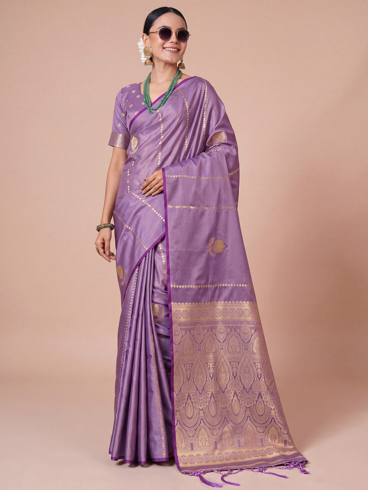 Woman wearing lavender satin silk saree with traditional indian motif work and lavender blouse