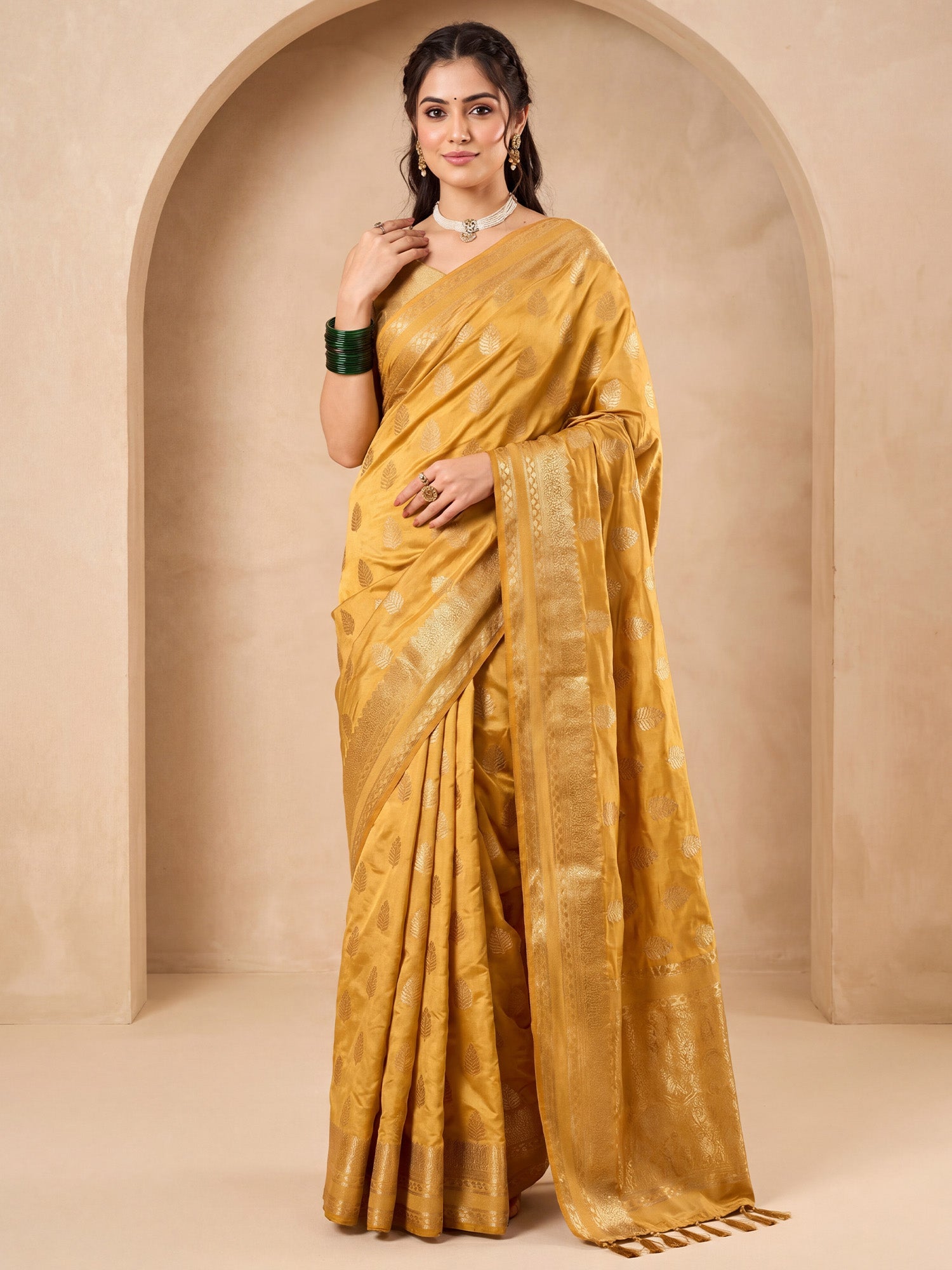 Woman wearing cream nylon saree with zari butta (metallic motif) work and dark blue blouse