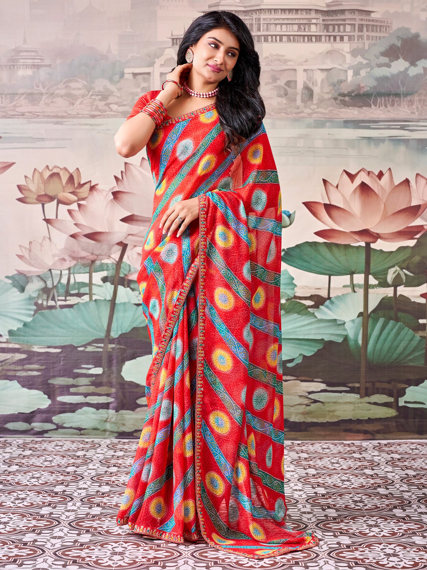 Woman wearing red georgette saree with bandhani tie-dye dot work and red blouse