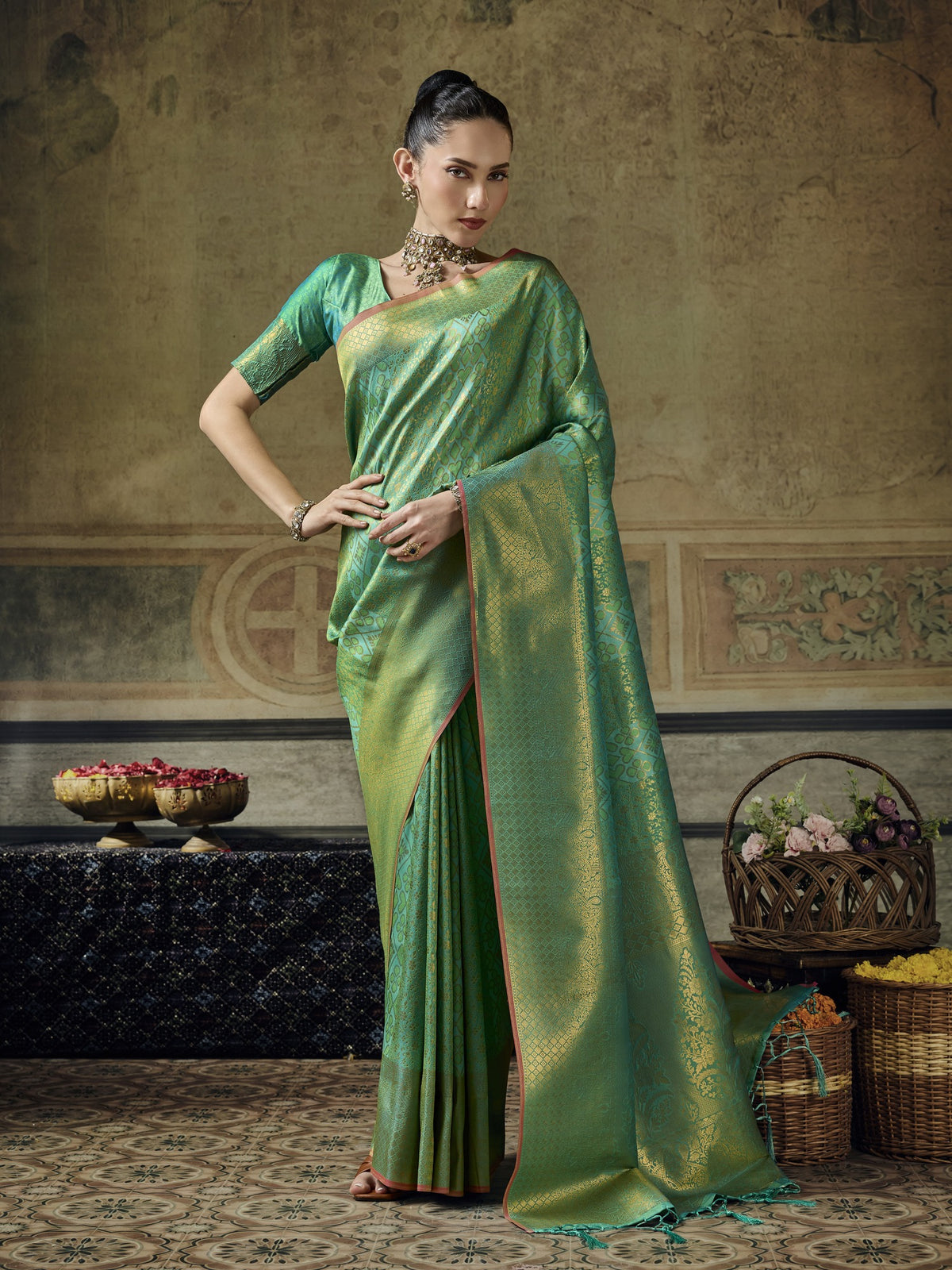 Woman wearing teal green pure silk saree with woven motif design and teal green blouse