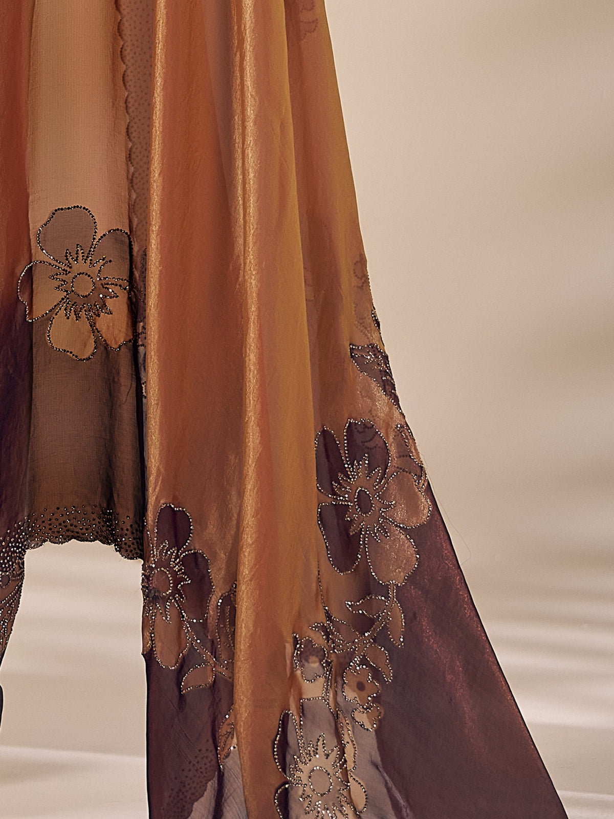 Pallu detail of bronze satin silk saree showing ornamented surface design and scallop border