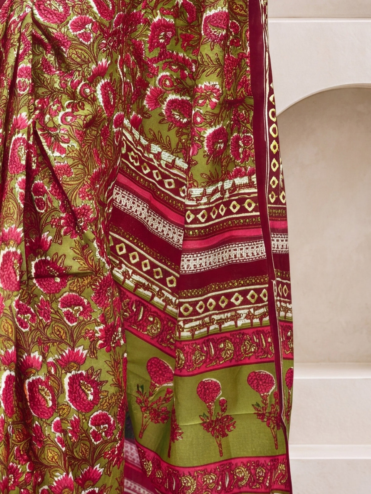 Pallu detail of olive cotton saree showing botanical floral and leaf design and printed border