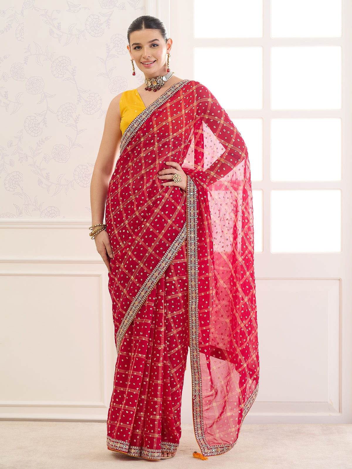 Woman wearing red viscose saree with bandhani tie-dye dot work and mustard blouse