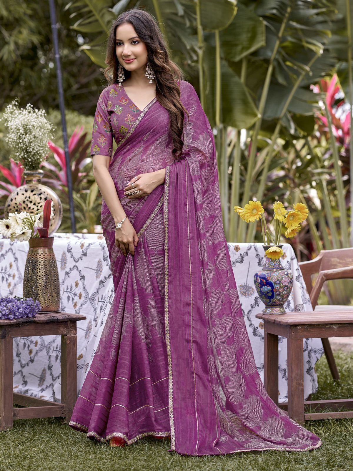 Woman wearing mauve chiffon saree with traditional indian motif work and mauve blouse