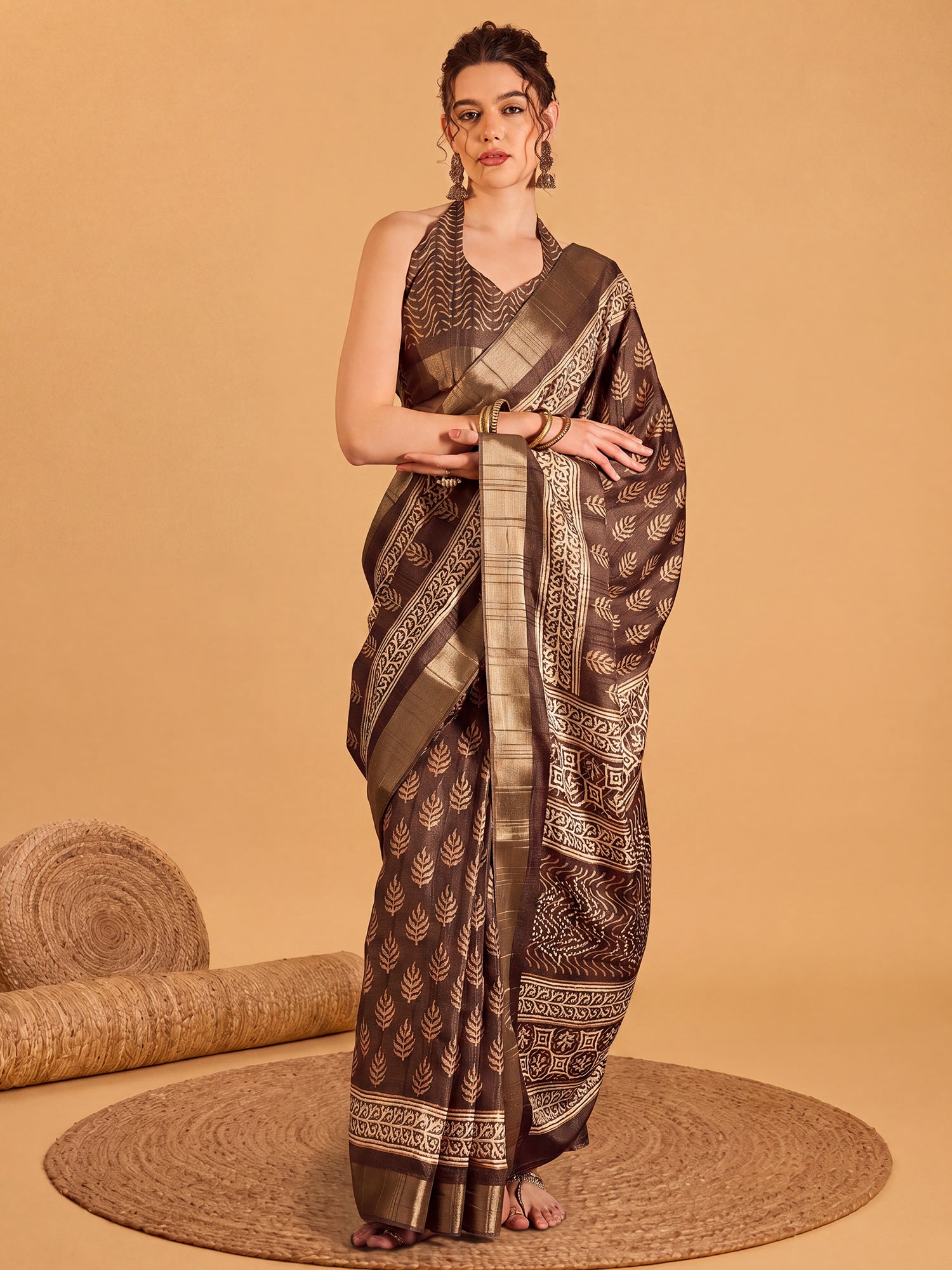 Woman wearing brown silk blend saree with dabu mud-resist print work and brown blouse