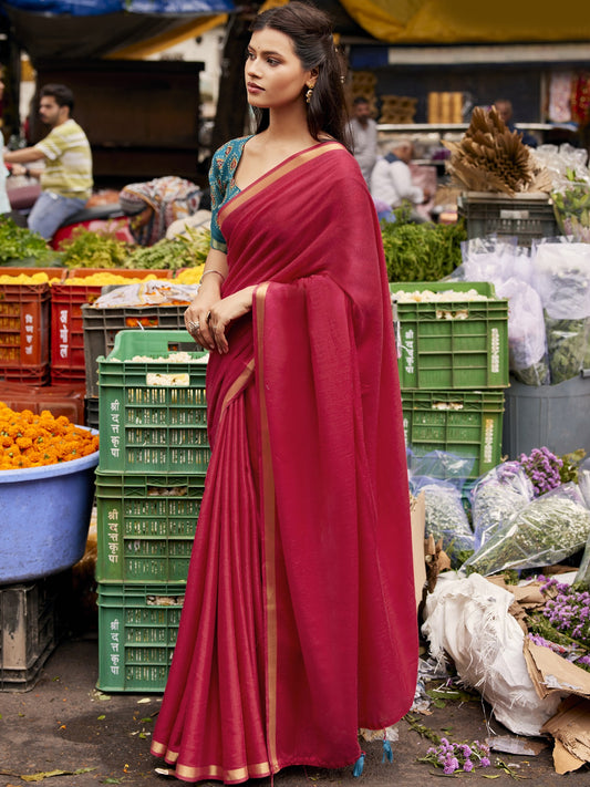 Woman wearing red cotton blend saree with clean solid-tone finish and turquoise blue blouse
