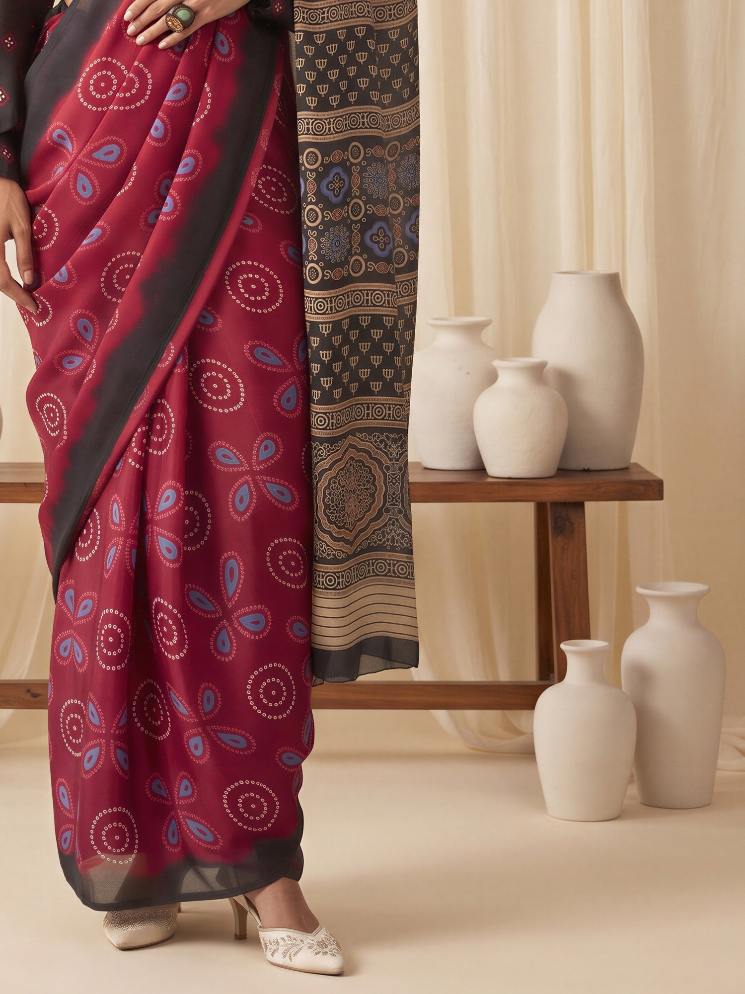 Pallu detail of maroon satin saree showing bagh block-print motif work and printed border