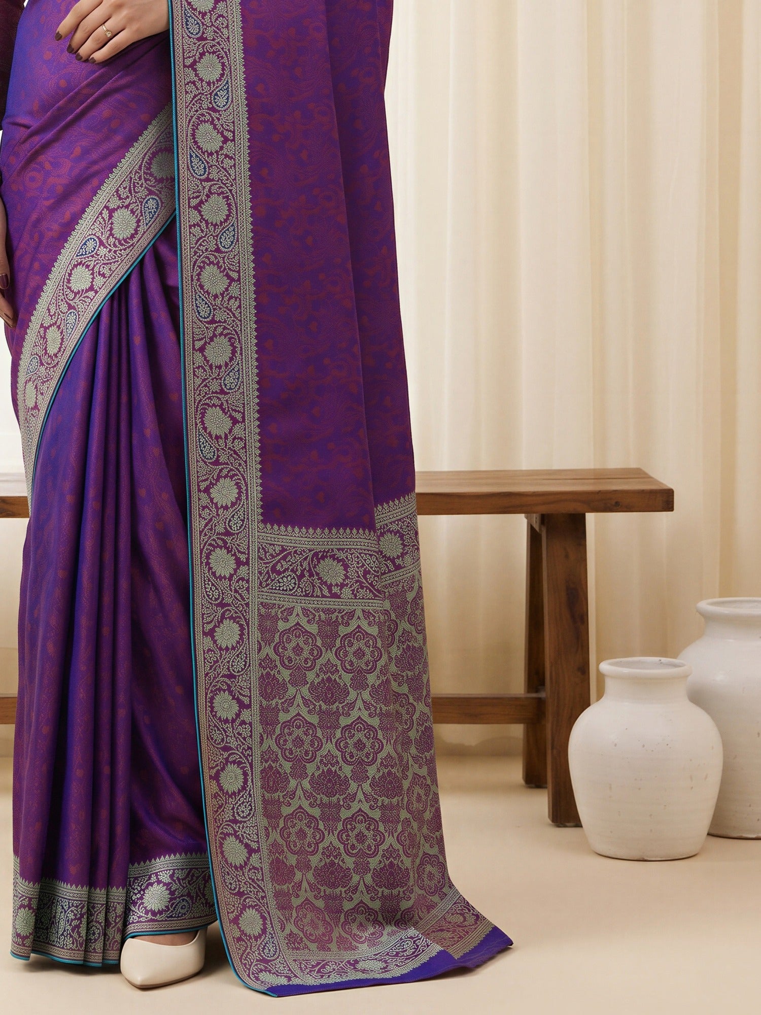 Pallu detail of purple silk blend saree showing traditional indian motif work and woven design border