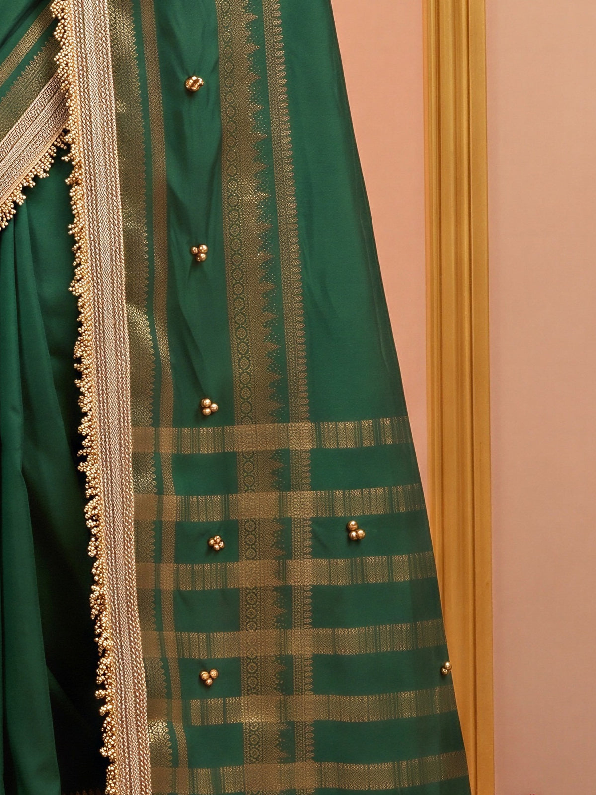 Pallu detail of green soft silk saree showing woven motif design and zari border