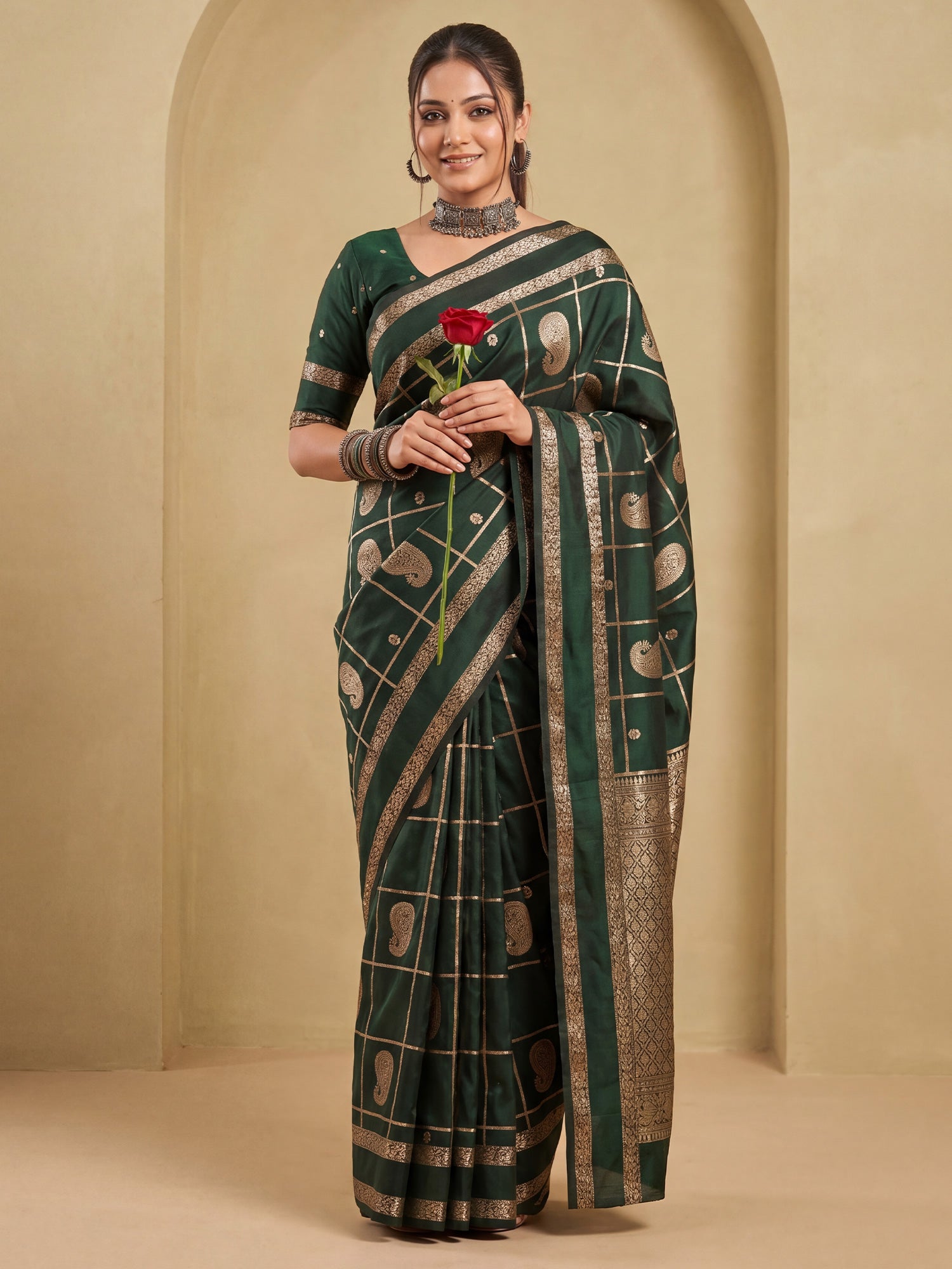 Woman wearing green silk blend saree with zari butta (metallic motif) work and green blouse
