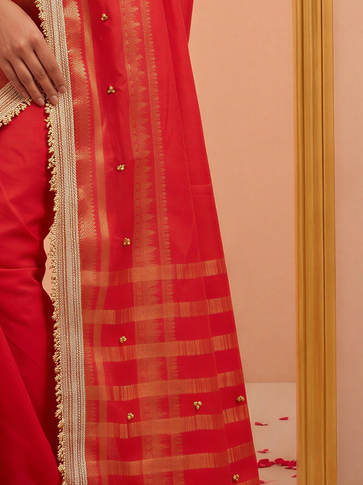 Pallu detail of red soft silk saree showing woven motif design and zari border