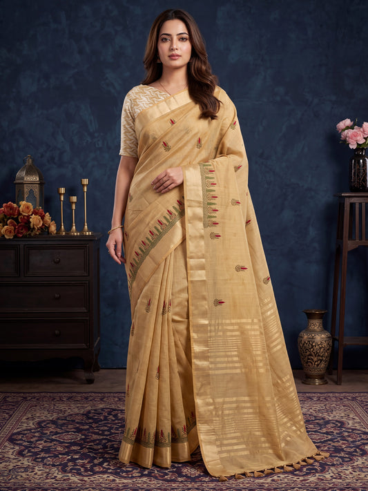 Woman wearing beige cotton linen saree with embroidered motif work and beige blouse