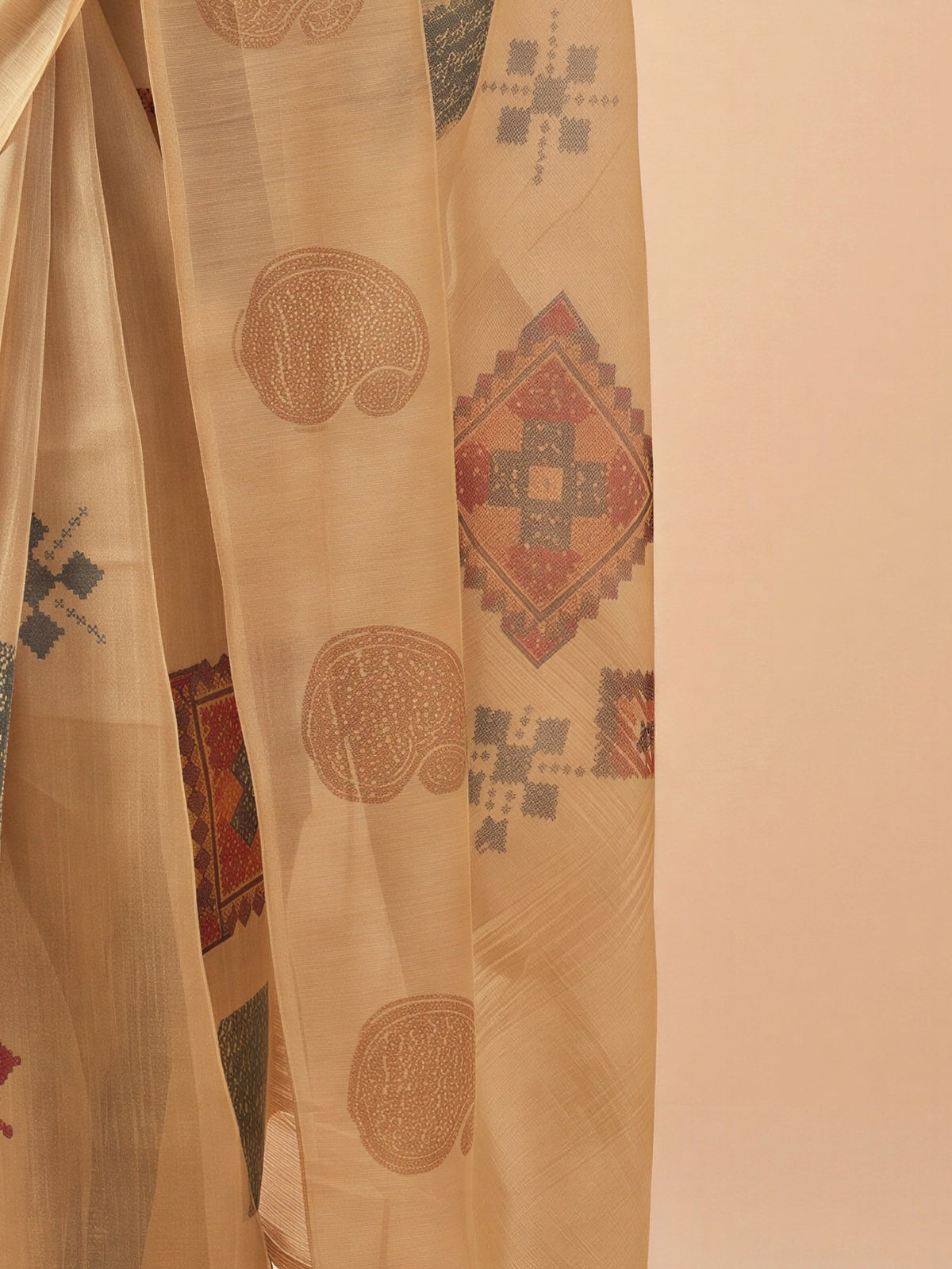Pallu detail of beige tissue saree showing traditional indian motif work and no border border